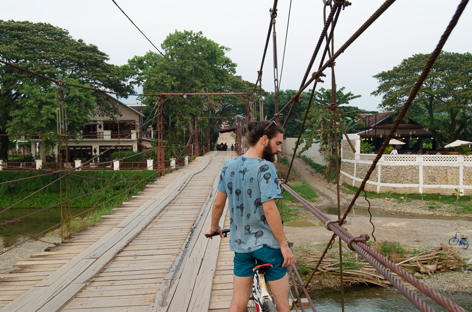crossing a bridge in Vang Vieng