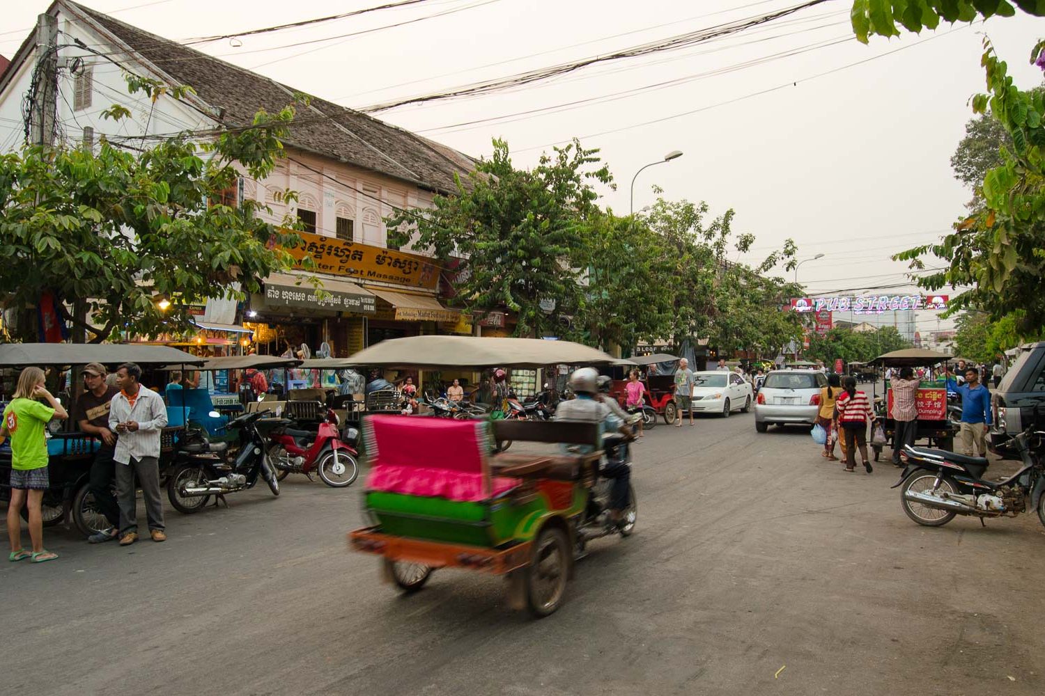 A tuk tuk speeding through the busy pub street in Siem Reap, Cambodia.